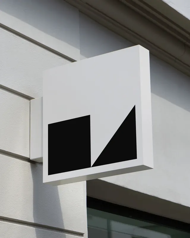 Geometric blade sign on stone facade, minimal, geometric, light