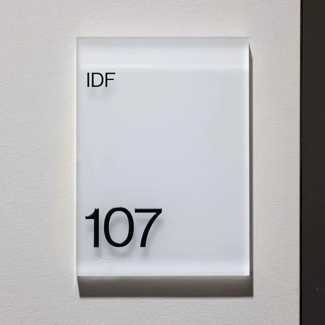 Frosted IDF 107 room sign, minimal, corporate-clean, light