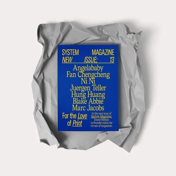 System Magazine cover, yellow type on cobalt over crumpled paper, editorial, minimal, high-contrast