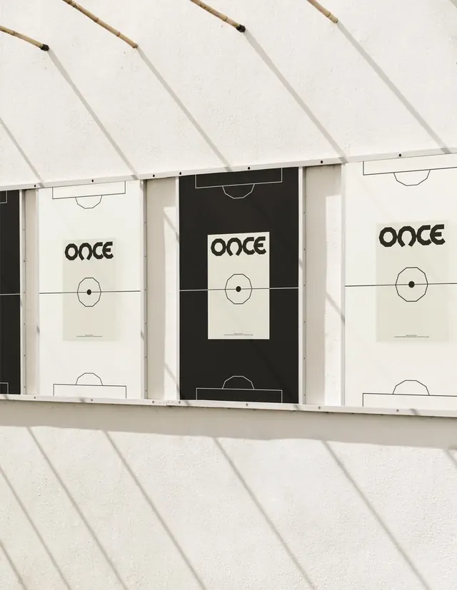 ONCE football posters on sunlit wall, minimal, geometric, muted