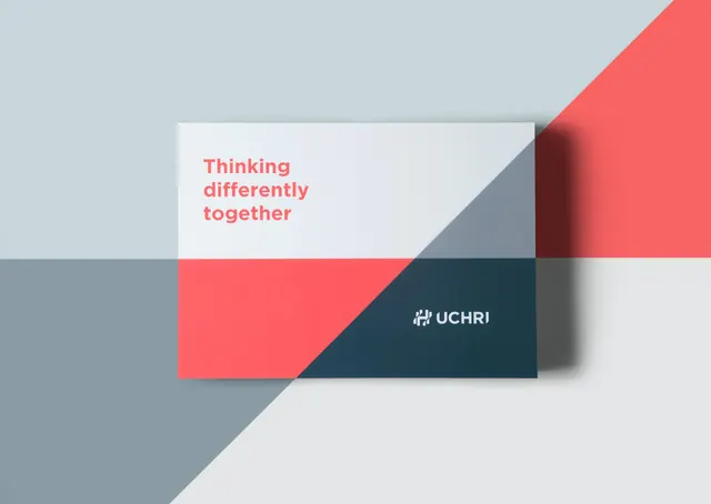 UCHRI card mockup with diagonal coral and navy color split, minimal, geometric, light