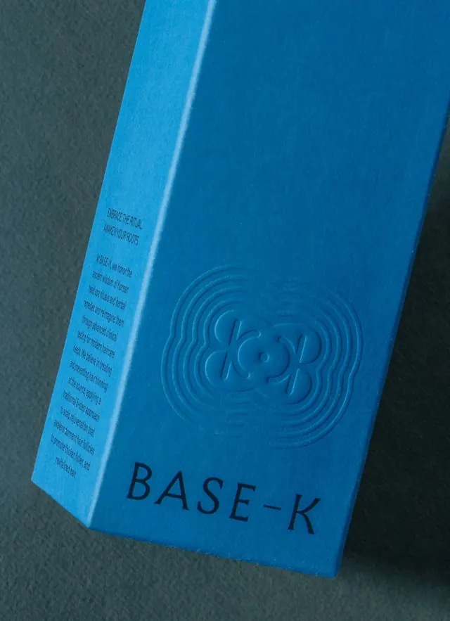 BASE-K blind-embossed blue haircare box, minimal, luxury, cool