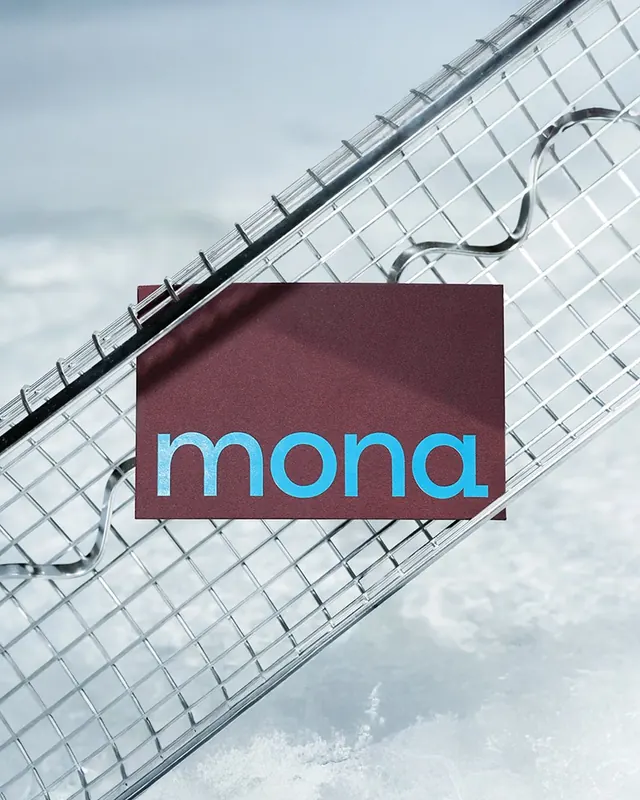 Mona maroon business card on wire mesh, minimal, corporate-clean, cool