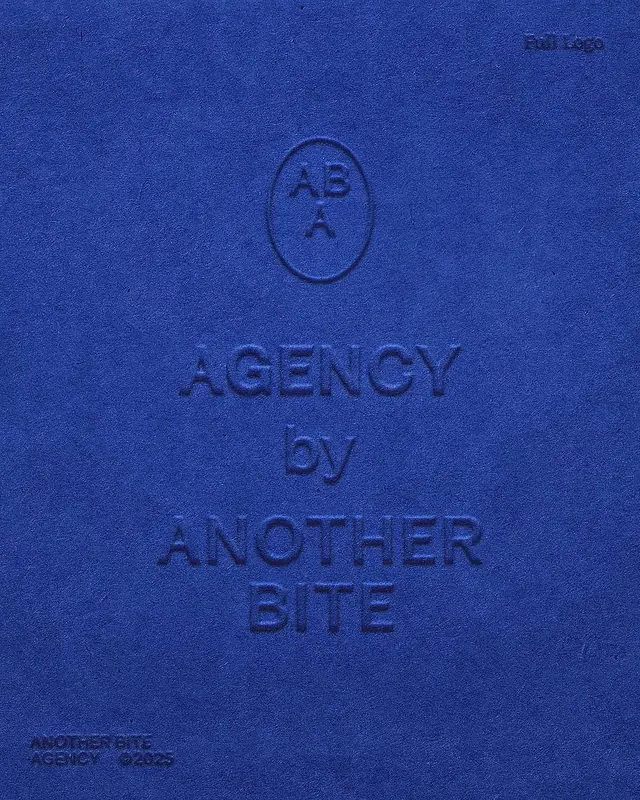 Blind-embossed agency logo on cobalt suede, minimal, luxury, vibrant
