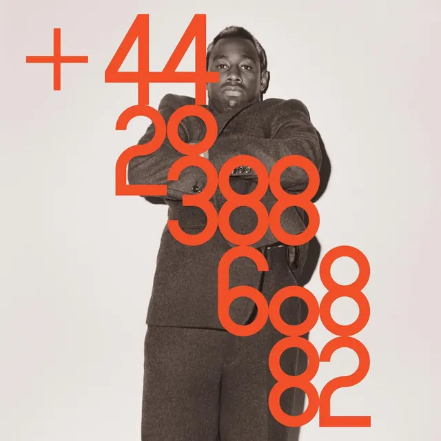 Orange phone-number type over greyscale portrait, editorial, photographic, warm