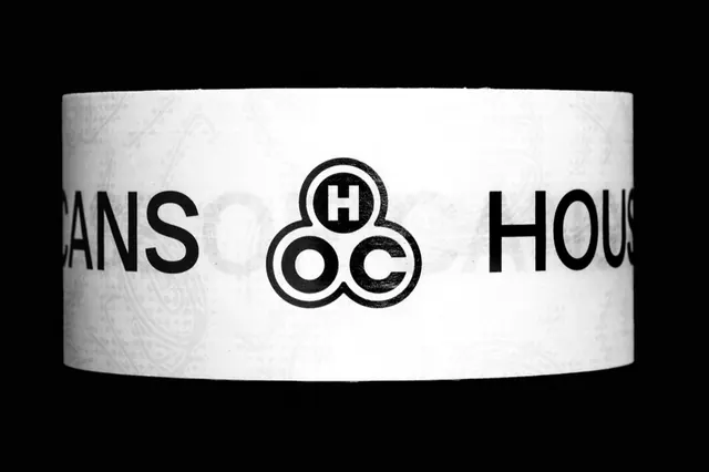 Monochrome geometric logo on white label band, minimal, geometric, light