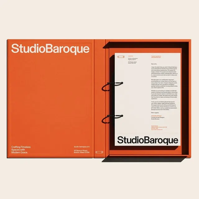 StudioBaroque branding book with burnt-orange binding, editorial, corporate-clean, warm