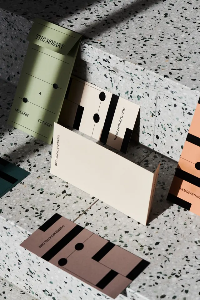 Luxury stationery flat lay with terrazzo surface and muted earth tones, minimal, geometric, light
