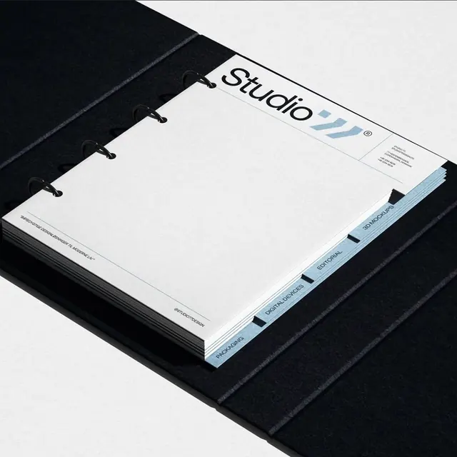 Studio brand identity on spiral notebook, minimal, editorial, dark