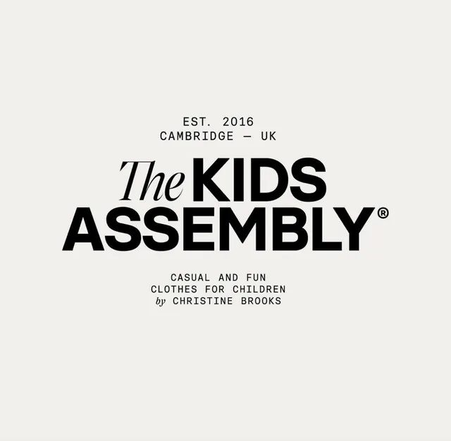 The Kids Assembly children's clothing brand lockup, minimal, corporate-clean, dark