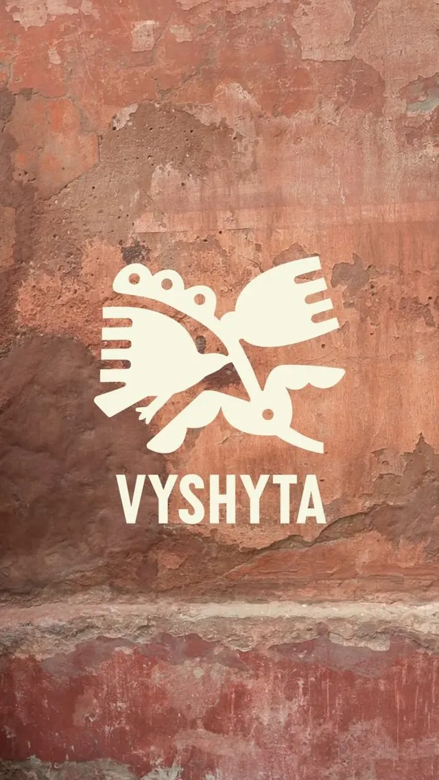 Vyshyta ornamental bird symbol on weathered plaster, minimal, geometric, earthy