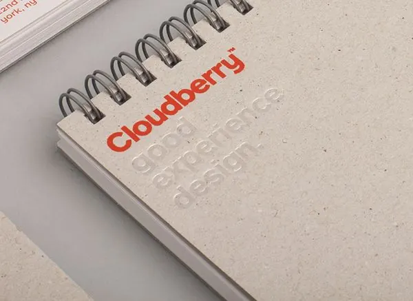 Cloudberry spiral-bound notebook with red logo, minimal, editorial, light