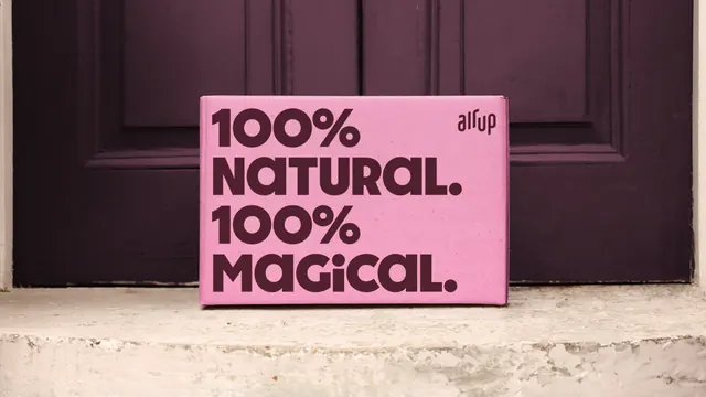 air up pink shipping box on a doorstep, photographic, typographic, warm