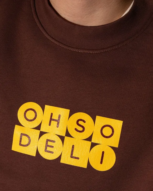 Apparel graphic with interlocking grid letters, minimal, playful, warm