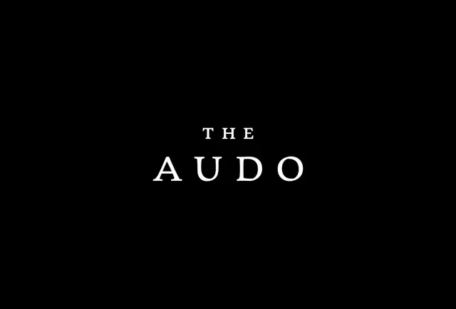 The Audo: elegant spaced serif wordmark, minimal, monochrome, dark