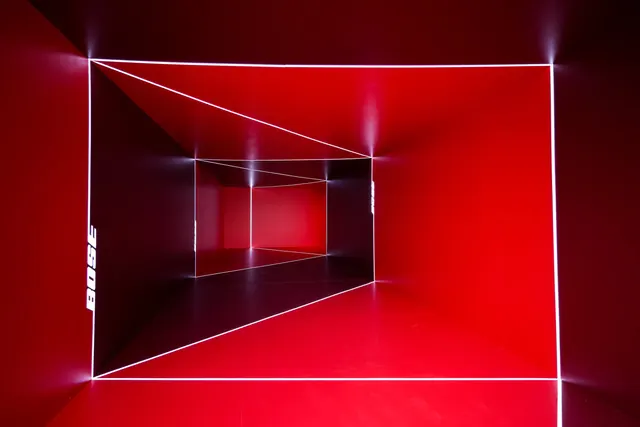 Bose red light corridor with vertical wordmarks, architectural, geometric, vibrant