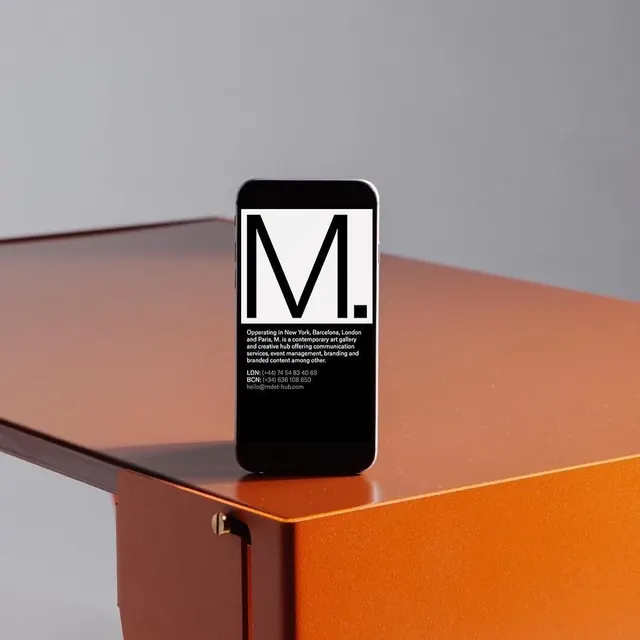 M. monogram on phone mockup, minimal, geometric, dark