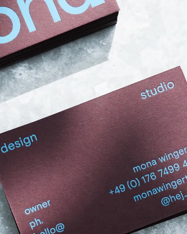 Designer business cards: burgundy and cyan type contrast, minimal, corporate-clean, light