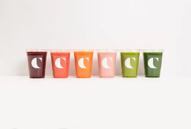 Colorfield smoothie cup lineup in a color spectrum, minimal, photographic, light