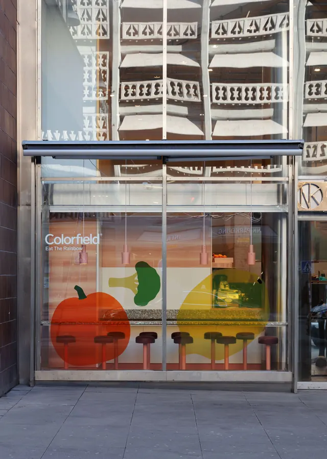 Colorfield storefront glazing with translucent produce shapes, minimal, geometric, vibrant