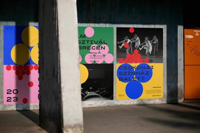 Debrecen 2023 event posters pasted on a concrete wall, geometric, swiss, vibrant