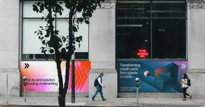 Deserve storefront hoarding graphics on a city street, gradient-heavy, photographic, muted