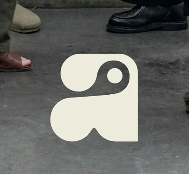 Biomorphic geometric logo in cream and charcoal, minimal, geometric, muted