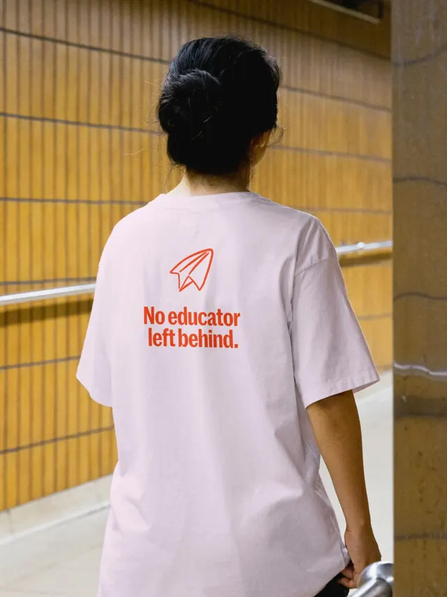 Education Elements slogan tee in pale pink, minimal, photographic, warm