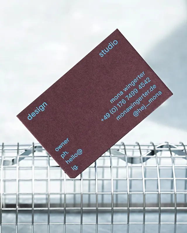 Angled business card with cyan typography, minimal, corporate-clean, dark