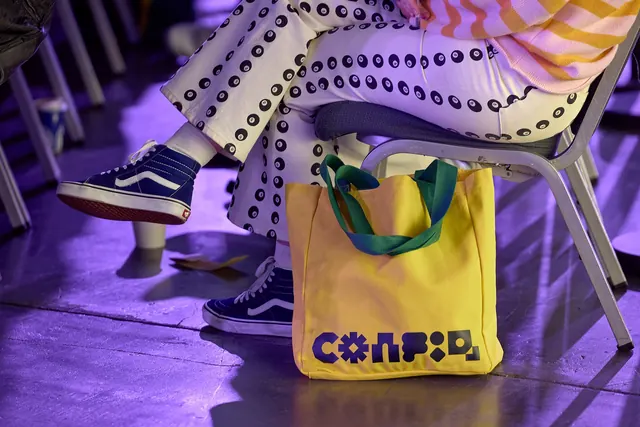 Config 2024 yellow tote in the audience, photographic, cinematic, vibrant