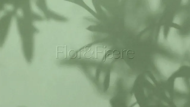 Flor and Fjaere embossed wordmark under leaf shadow, minimal, luxury, muted