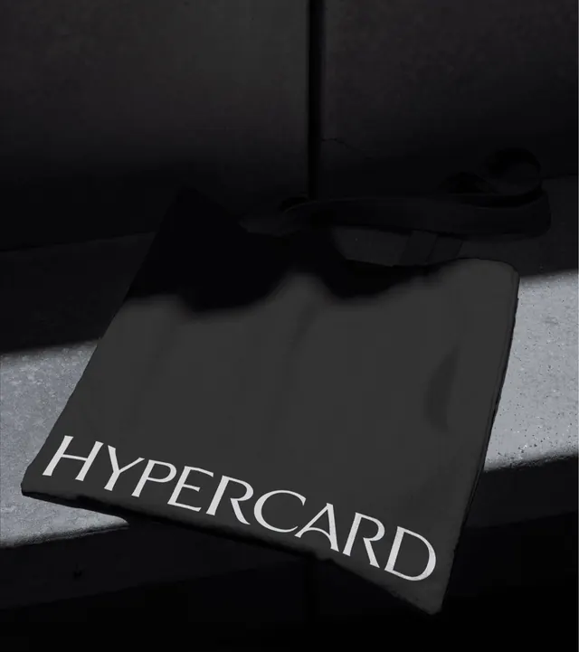Hypercard tote bag on concrete steps, photographic, minimal, dark