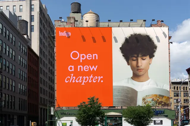 Indigo split building billboard reading Open a new chapter, photographic, typographic, vibrant