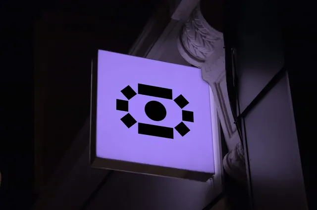 Infer illuminated projecting sign at night, geometric, minimal, dark