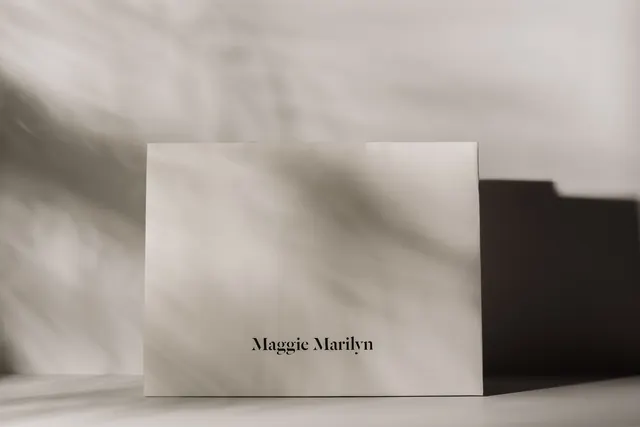 Branding materials with serif wordmark on neutral background, minimal, editorial, light