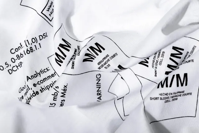 Shipping company identity on clothing labels, minimal, swiss, monochrome