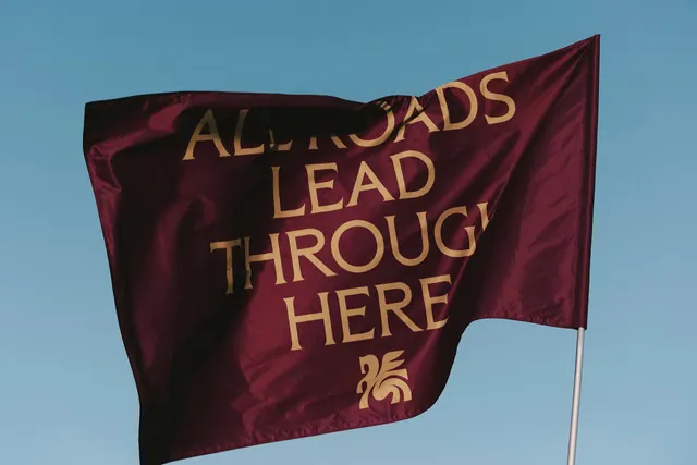 Maroon flag with winged crest, minimal, luxury, vibrant