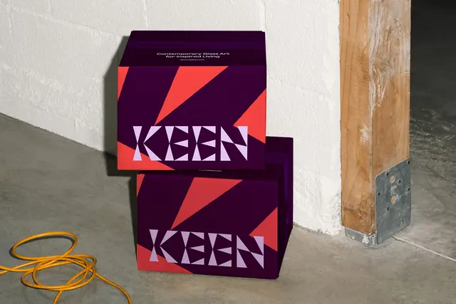 KEEN shipping boxes stacked in a workshop, photographic, geometric, vibrant