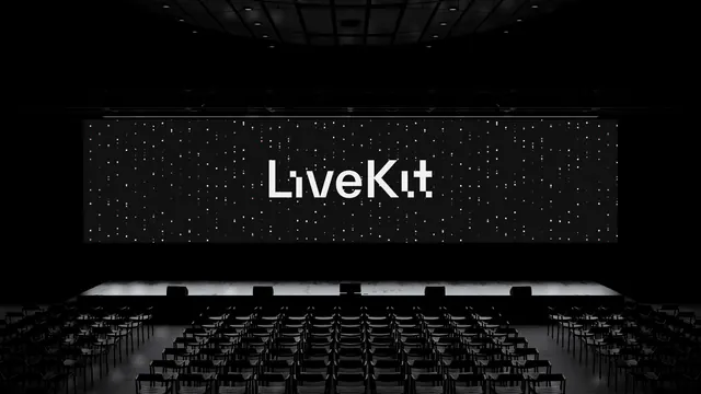 LiveKit wordmark on a conference LED wall, dark-mode, technical, dark