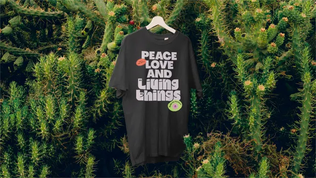 Living Things slogan t-shirt on cactus backdrop, playful, photographic, dark