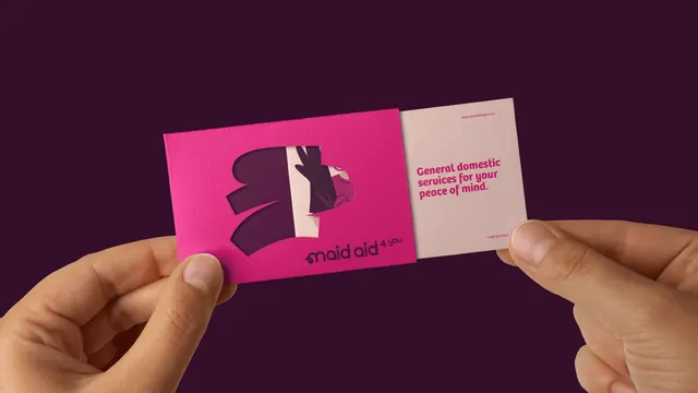 Maid Aid business cards held in hand, photographic, playful, vibrant
