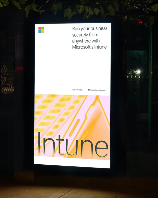 Microsoft Intune digital street poster at night, photographic, gradient-heavy, warm