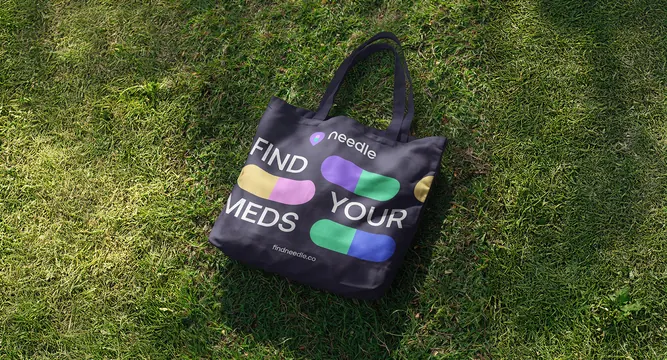 Needle tote bag on grass, photographic, playful, dark