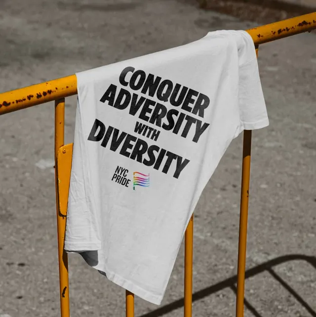 NYC Pride slogan T-shirt on a street railing, photographic, typographic, muted