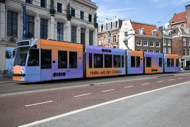 Odido gradient tram livery on an Amsterdam street, photographic, gradient-heavy, vibrant
