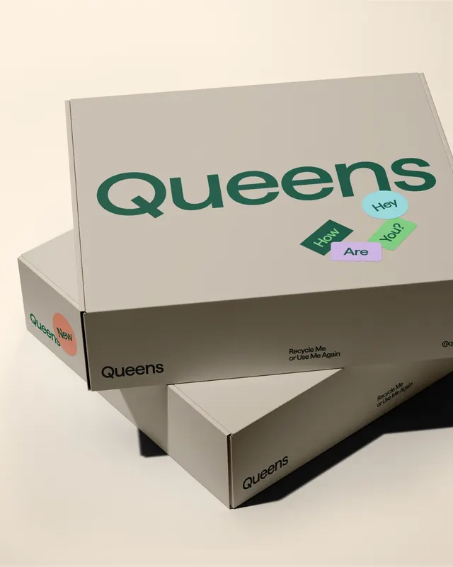 Queens stacked shipping boxes with sticker cluster, minimal, 3d-render, neutral