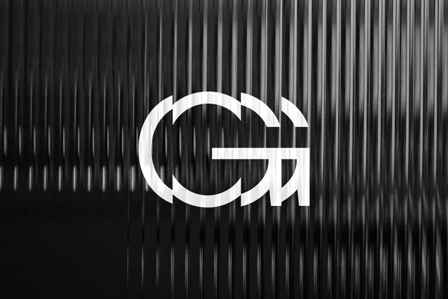 GW monogram logo on corrugated surface, minimal, monochrome, high-contrast