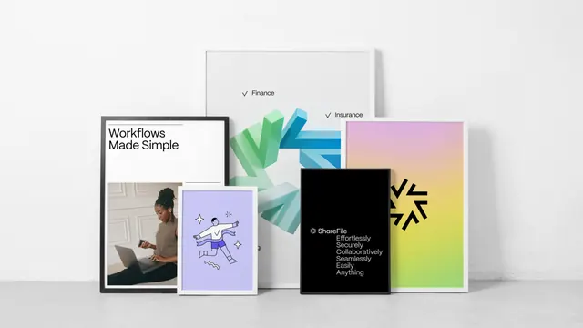 ShareFile framed poster suite leaning against a white wall, minimal, corporate-clean, light