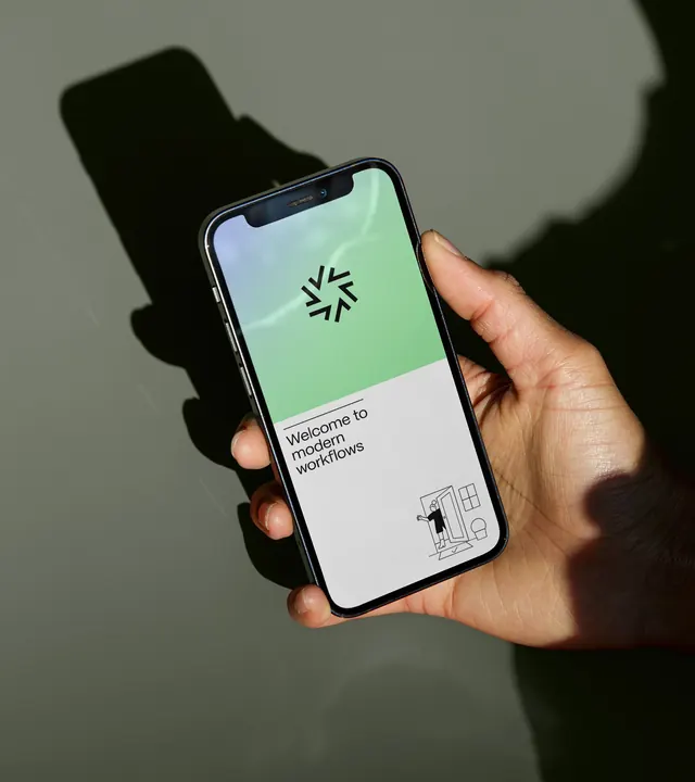 ShareFile app welcome screen held in hand against olive wall, minimal, photographic, light