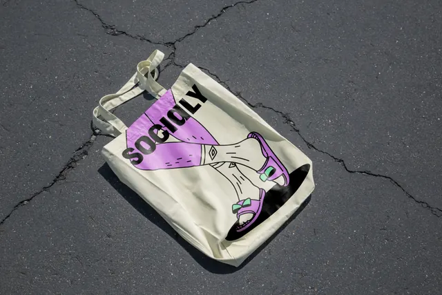 Socialy tote bag on asphalt, illustrated, line-art, light